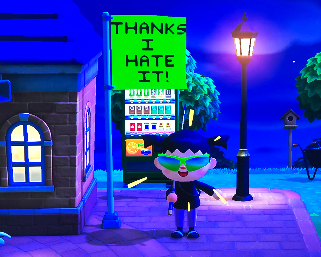 A picture of the video game Animal Crossing: Horizon; it’s night, and the character is yelling at the screen while a flag is waving in the flagpole with the lettering “THANKS I HATE IT!”