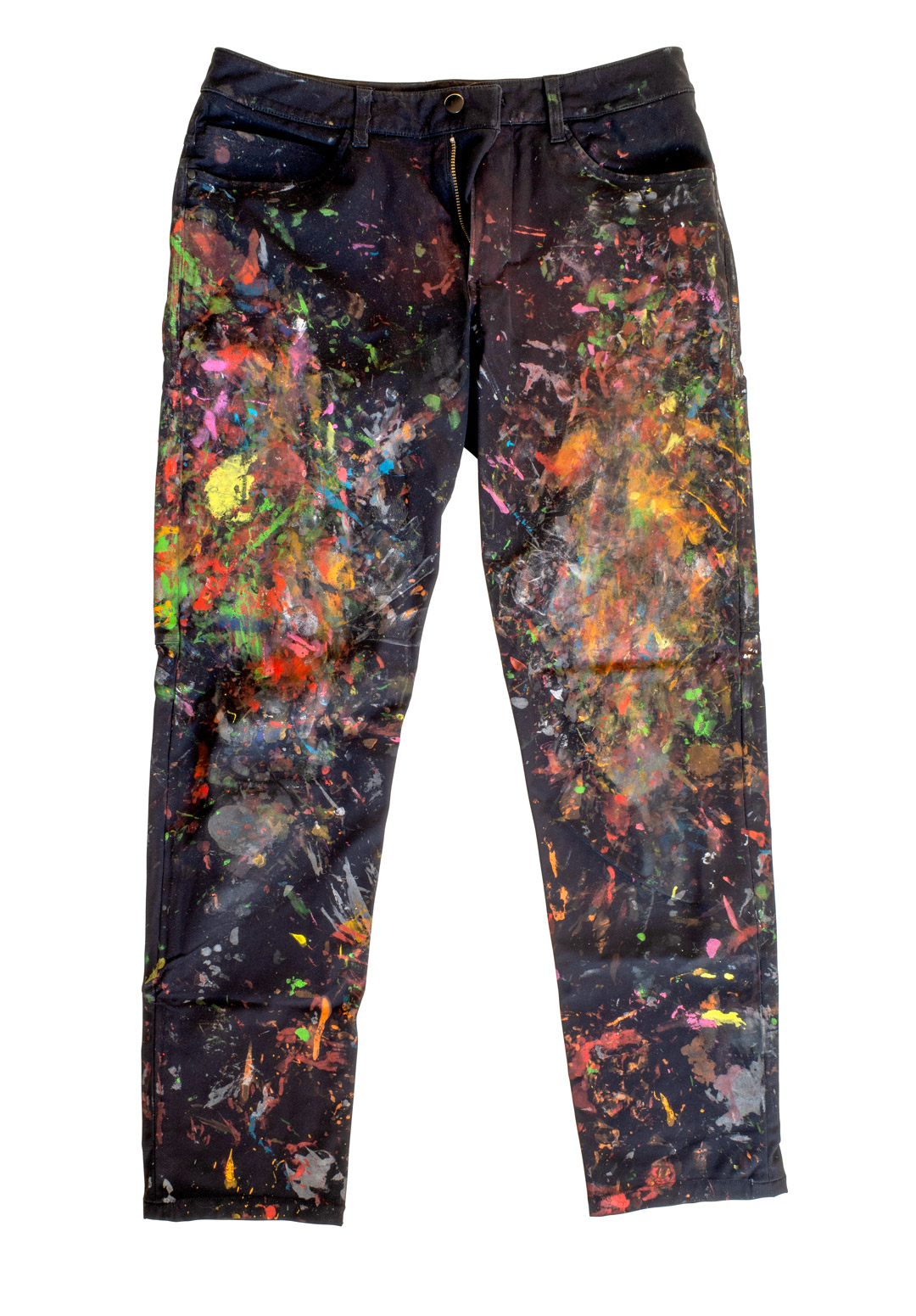 A black pair of pants with paint stains all over, especially around the thigh area.