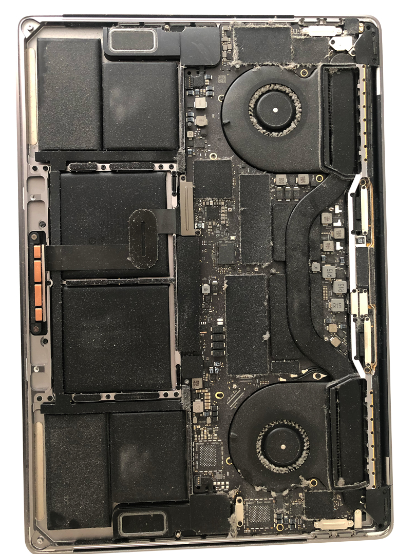 The inside of a MacBook Pro, full of dust and debris.