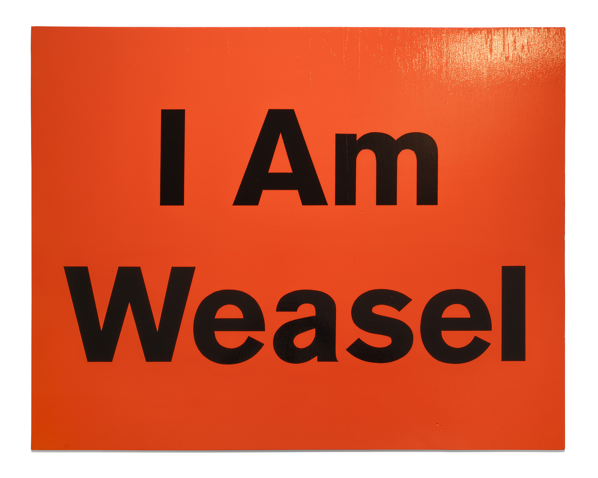 A painting with a solid orange background and the words ‘I Am Weasel’ in black lettering on top, on a wood canvas.